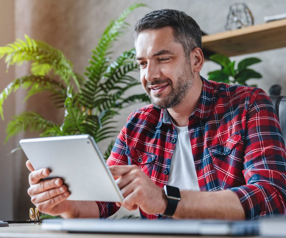 man-smiling-at-tablet